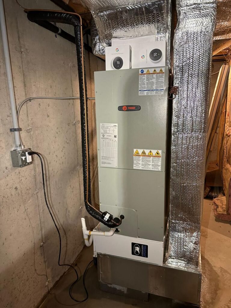 Trane air handler with insulated ductwork and smart thermostat controls in a basement