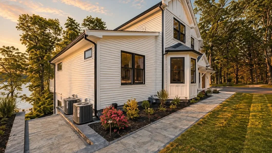 New Cape Cod waterfront home with central air conditioning condensers installed by High Flow HVAC
